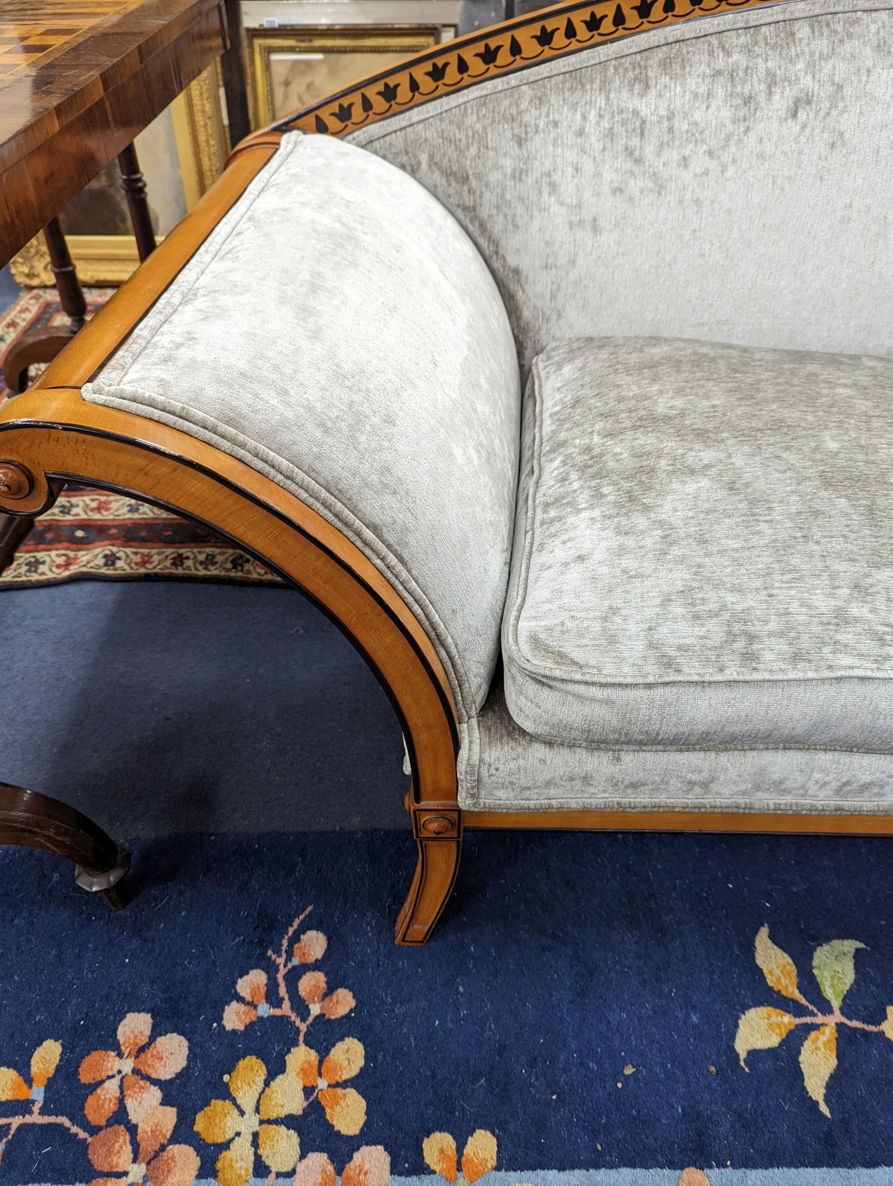 A 19th century Biedermier style part ebonised two seater scroll arm settee recently upholstered in grey velvet, length 180cm, depth 63cm, height 79cm